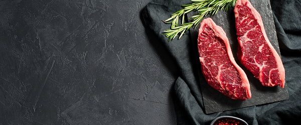 Raw beef ramp steak. Black background, top view.